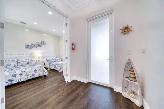a view of bedroom with furniture and wooden floor
