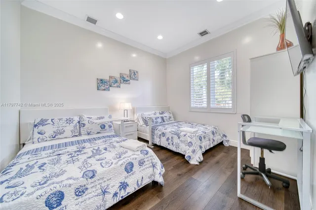 a bedroom with two beds and a table