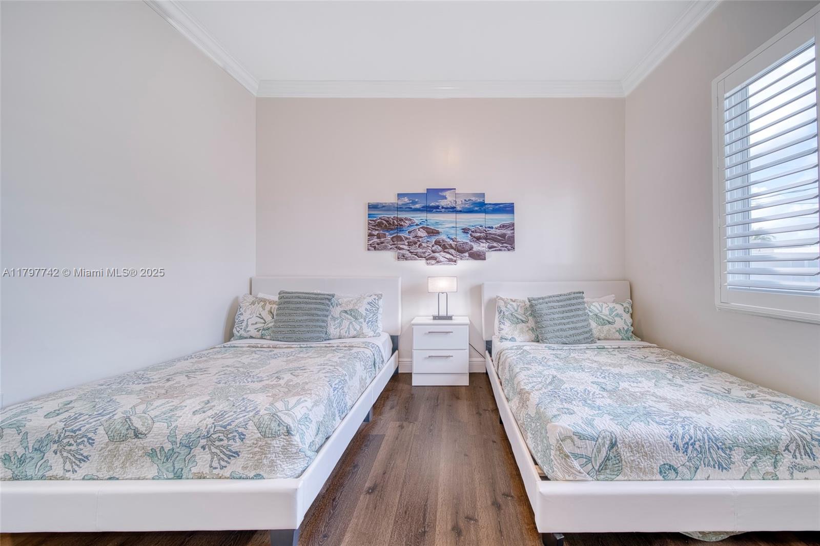 207 Southwest 11th Street Dania Beach, FL 33004 - Photo 27 of 37 a bedroom with a bed and wooden floor