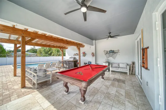 a living room with furniture a rug and white walls