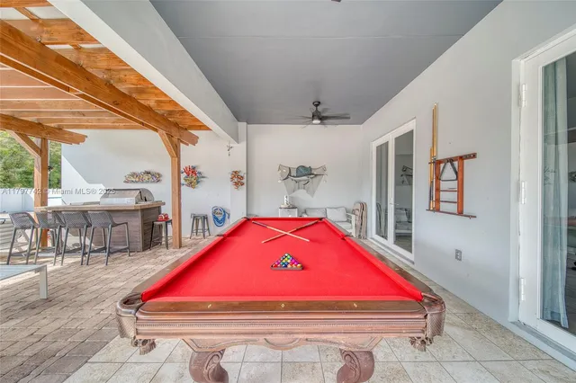 a room with furniture and pool table