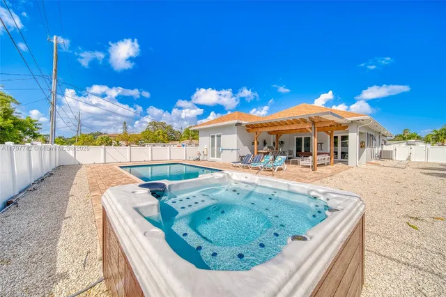 a view of a house with swimming pool and sitting area
