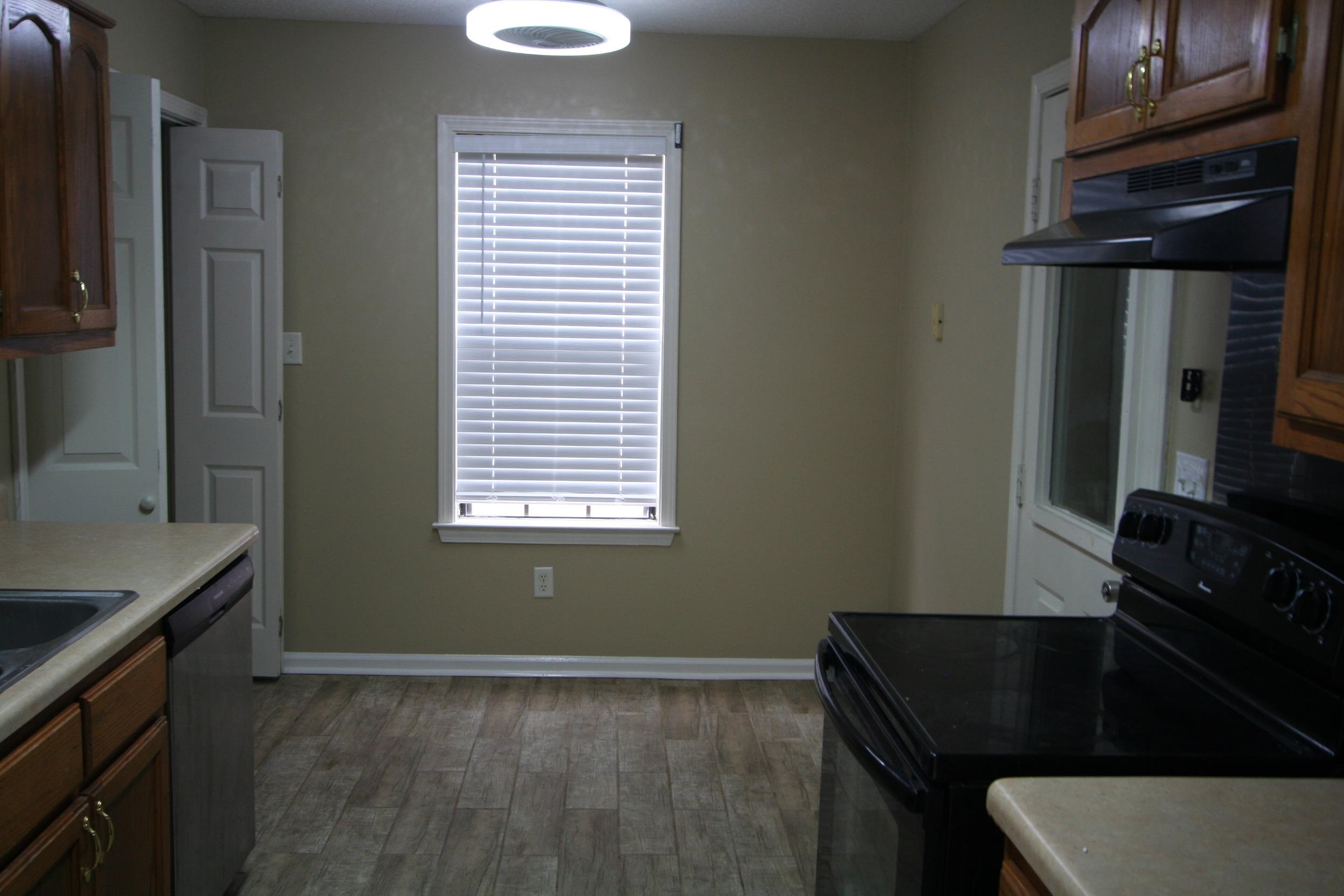 9793 Riggan Drive Olive Branch, MS 38654 - Photo 7 of 7 a kitchen with a sink a stove and a refrigerator