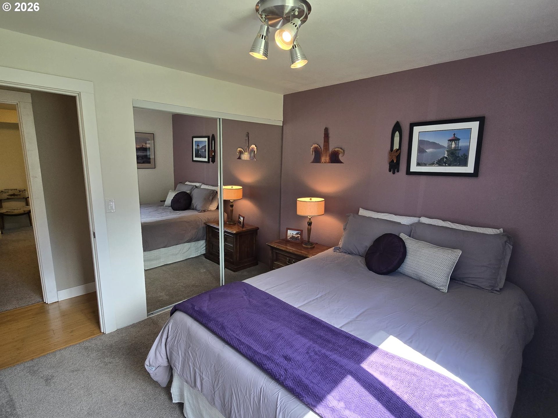 1265 34th Place Florence, OR 97439 - Photo 13 of 29 a bedroom with a bed and a chandelier