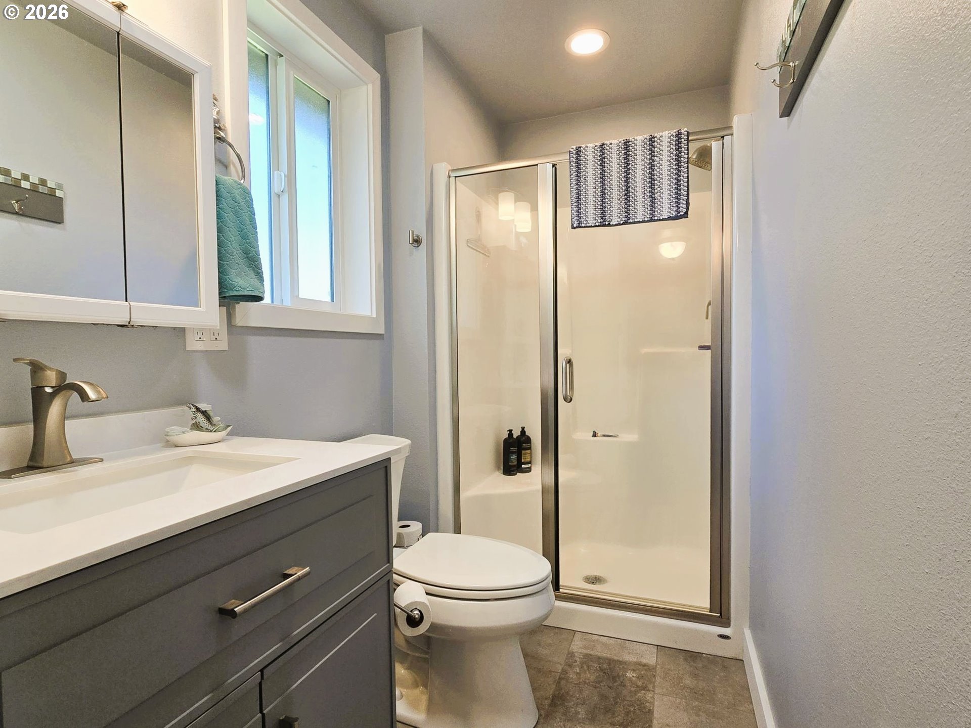 1265 34th Place Florence, OR 97439 - Photo 16 of 29 a bathroom with a sink a toilet and shower