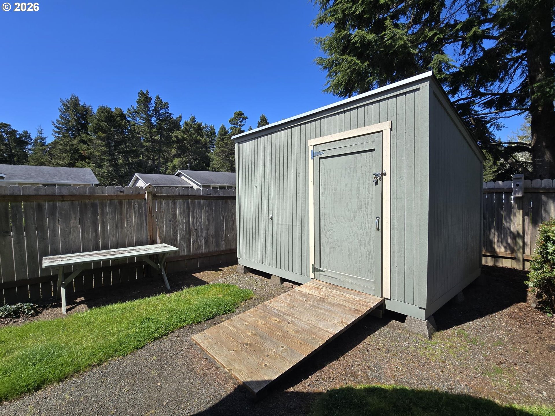 1265 34th Place Florence, OR 97439 - Photo 17 of 29 a backyard of a house with wooden floor and fence