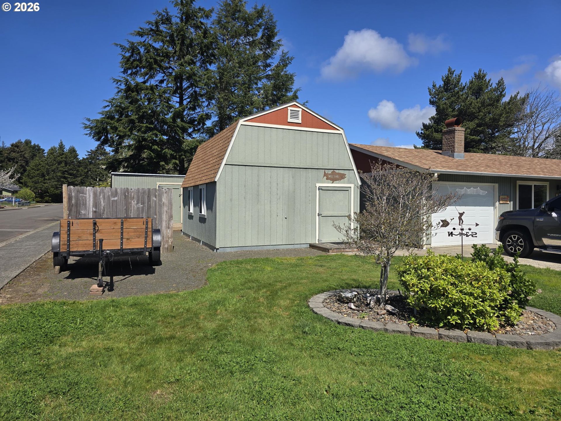 1265 34th Place Florence, OR 97439 - Photo 2 of 29 a view of a backyard with a garden and entertaining space