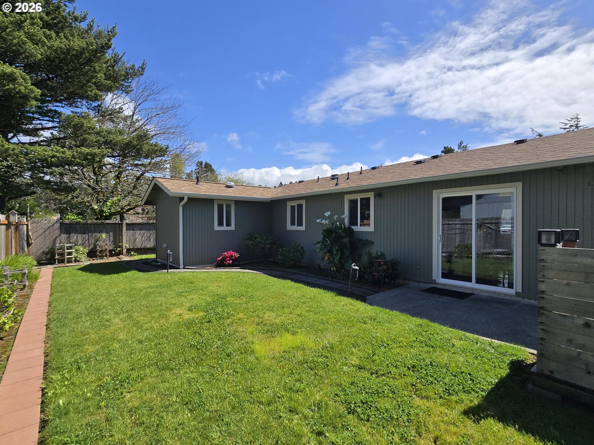 1265 34th Place Florence, OR 97439 - Photo 27 of 29 a view of a house with a yard