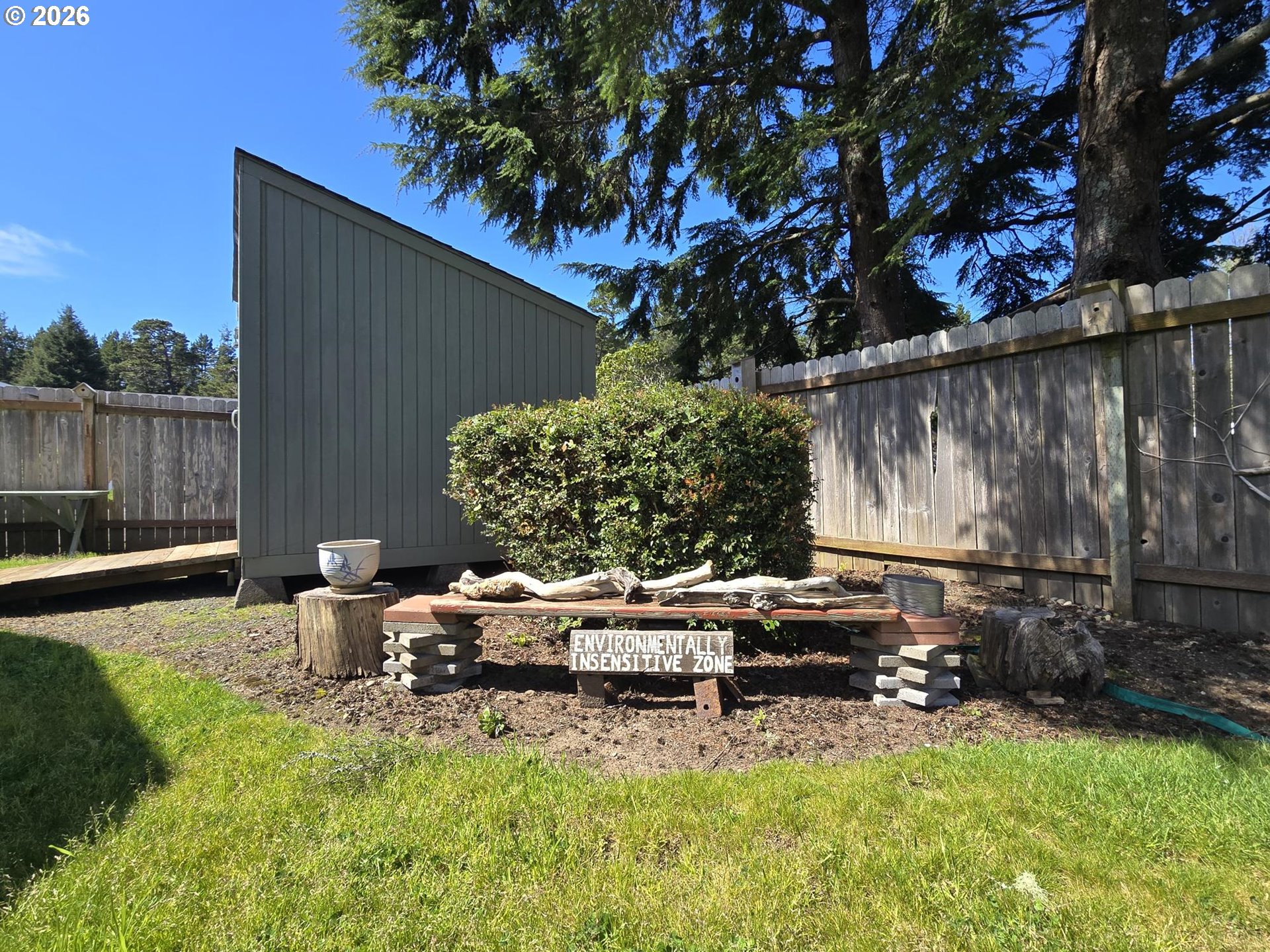 1265 34th Place Florence, OR 97439 - Photo 28 of 29 a backyard of a house with barbeque oven table and chairs