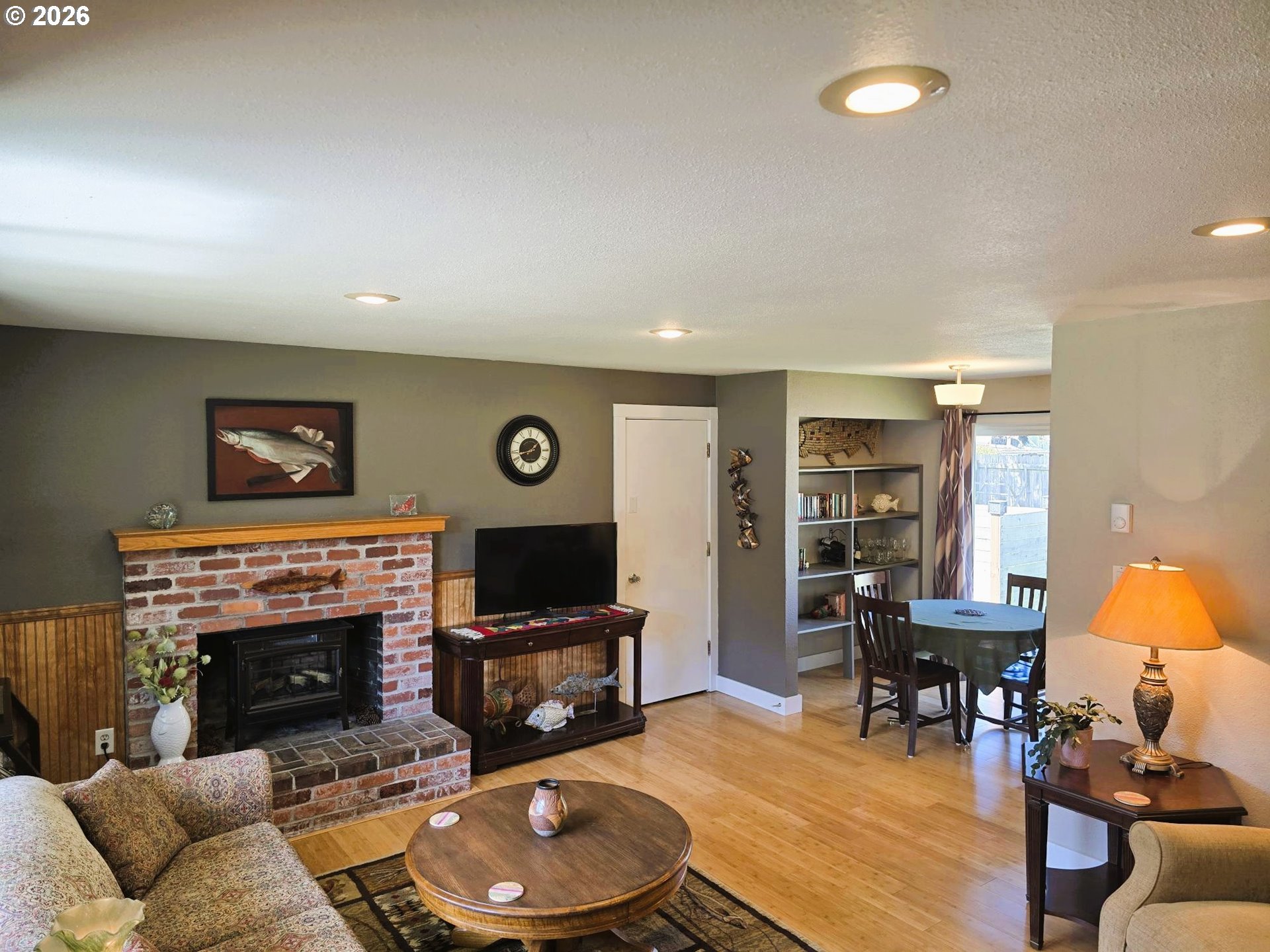 1265 34th Place Florence, OR 97439 - Photo 4 of 29 a living room with furniture a fireplace and a flat screen tv