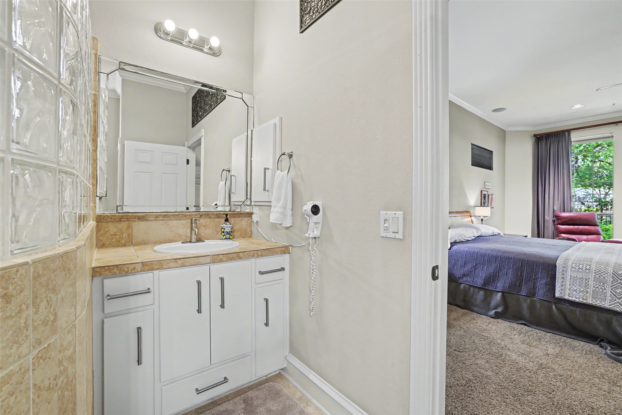 805 Boquilla Trail Georgetown, TX 78633 - Photo 27 of 40 a spacious bathroom with a granite countertop sink a mirror and a bathtub