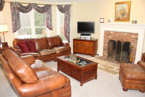 55 Edgewood Road Southborough, MA 01772 - Photo 3 of 18 a living room with furniture a flat screen tv and a fireplace