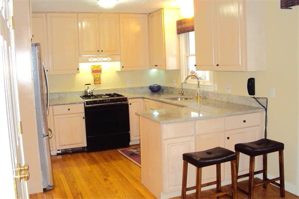 55 Edgewood Road Southborough, MA 01772 - Photo 7 of 18 a kitchen with a sink a stove and a refrigerator