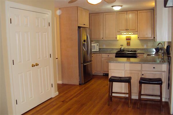 55 Edgewood Road Southborough, MA 01772 - Photo 8 of 18 a kitchen with a refrigerator a stove and a cabinets