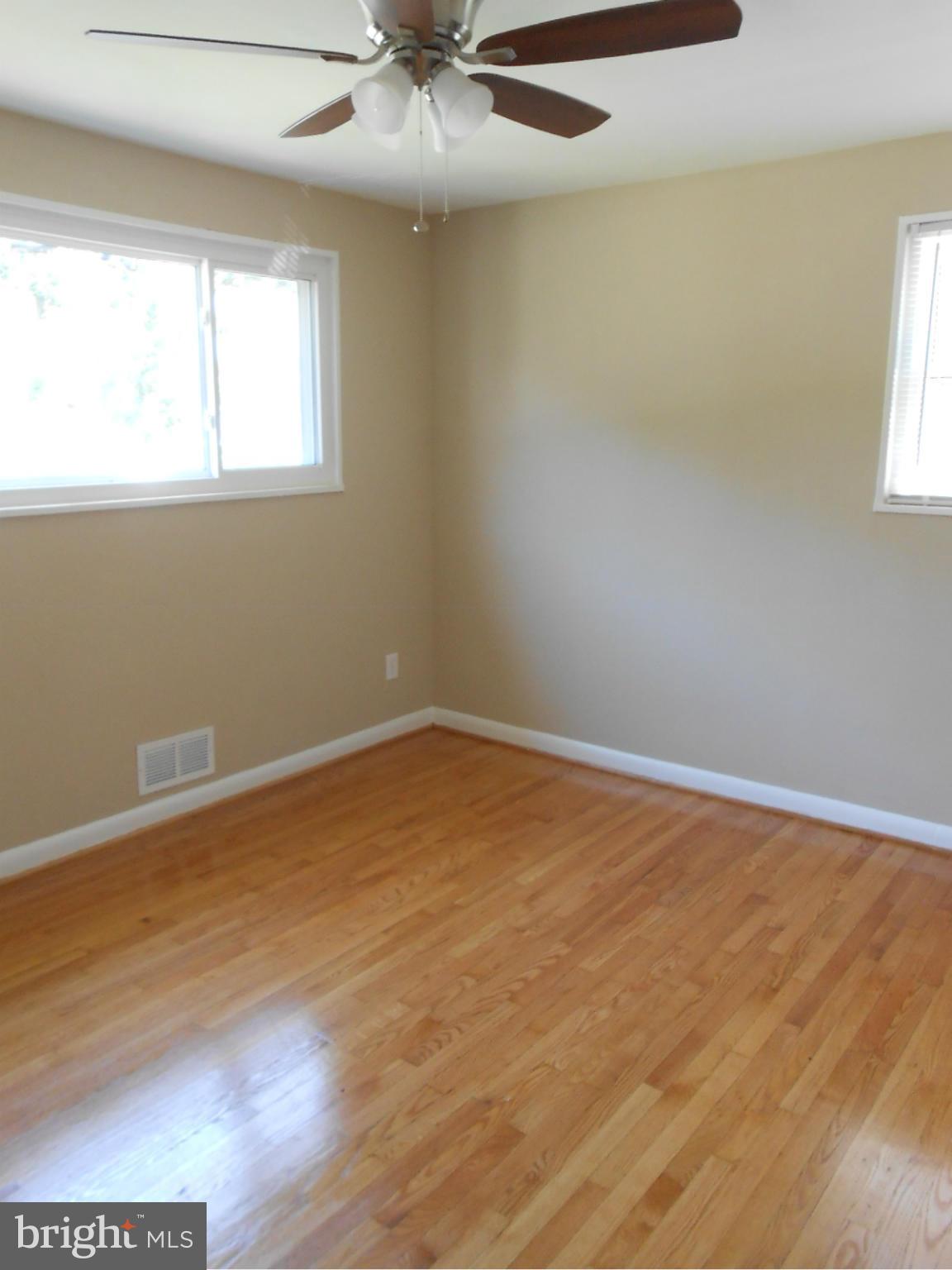 3916 Weller Road Silver Spring, MD 20906 - Photo 14 of 19 an empty room with wooden floor and windows