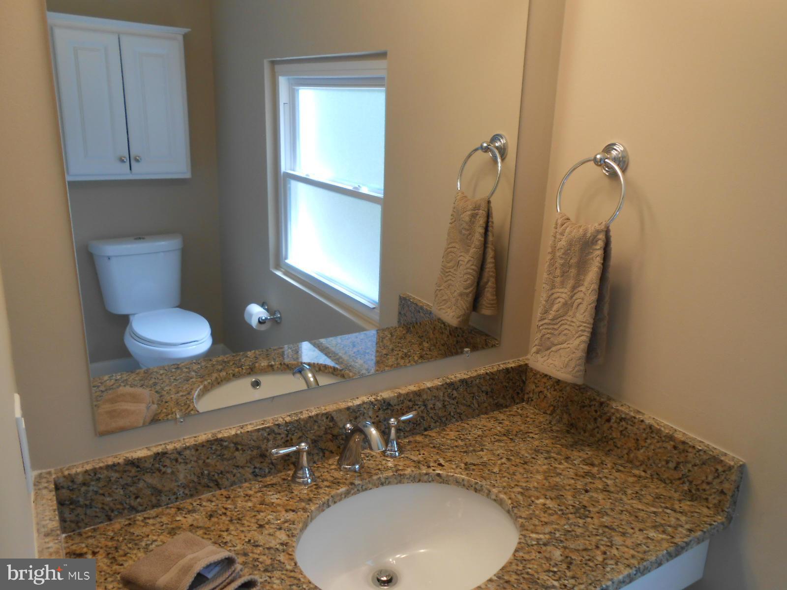 3916 Weller Road Silver Spring, MD 20906 - Photo 17 of 19 a bathroom with a granite countertop sink and a mirror