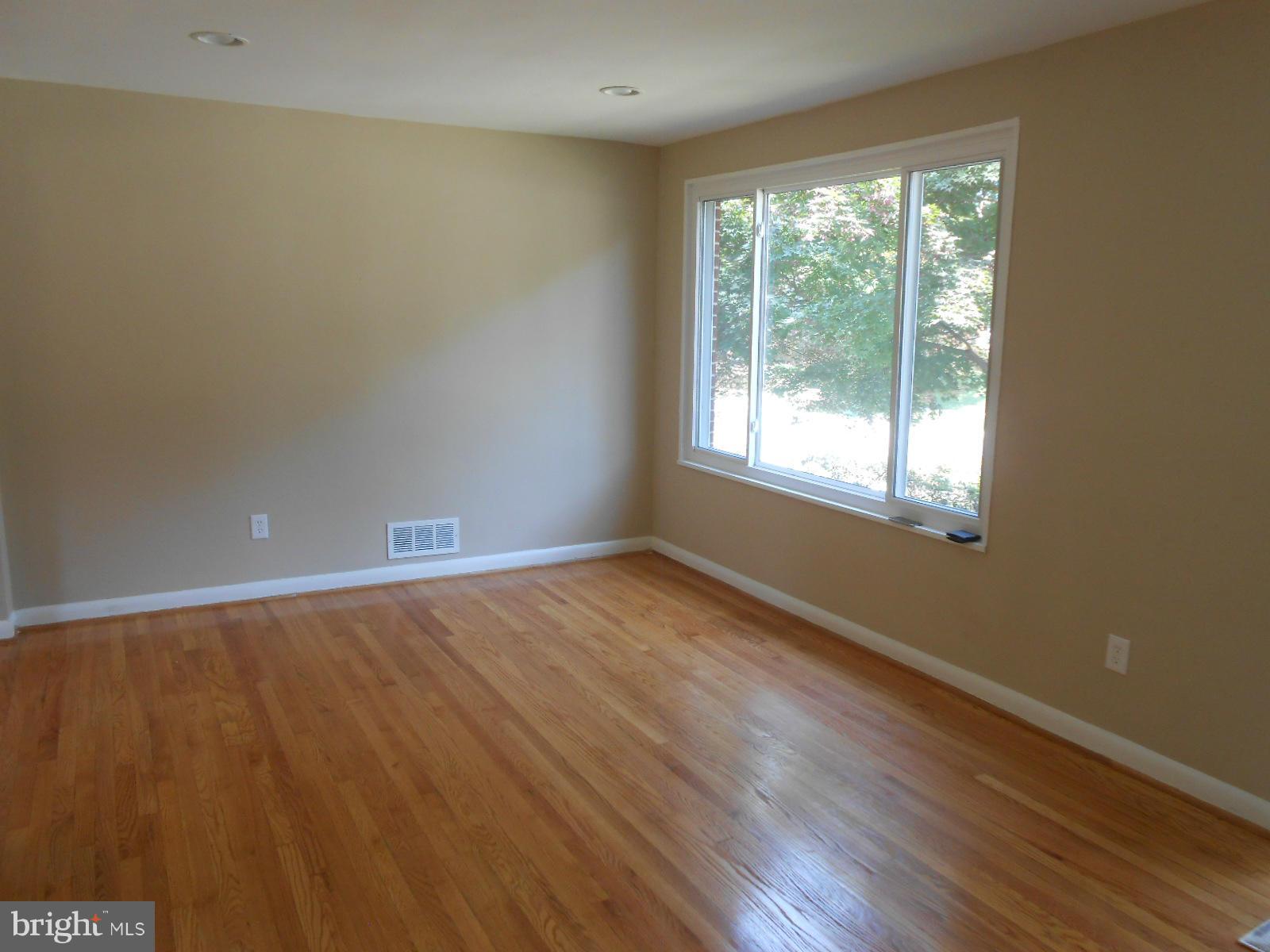 3916 Weller Road Silver Spring, MD 20906 - Photo 5 of 19 an empty room with wooden floor and windows