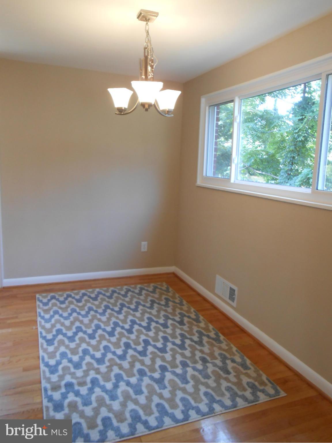 3916 Weller Road Silver Spring, MD 20906 - Photo 7 of 19 a view of a big room with wooden floor and windows