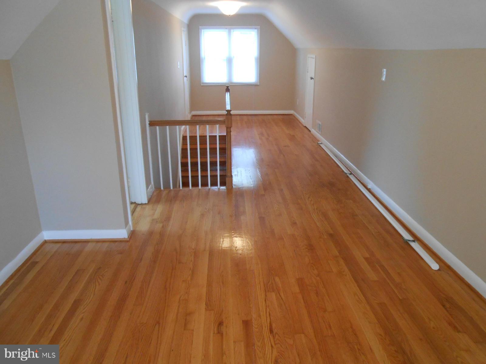 3916 Weller Road Silver Spring, MD 20906 - Photo 8 of 19 a view of a hallway with wooden floor