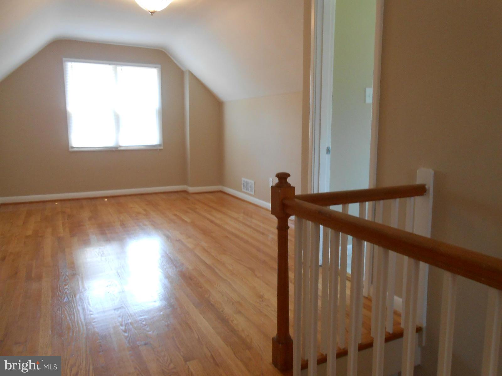 3916 Weller Road Silver Spring, MD 20906 - Photo 9 of 19 a view of a hallway with wooden floor and stairs