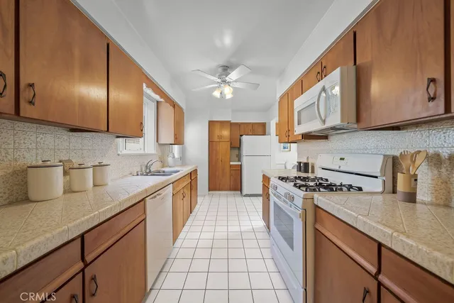 a kitchen with stainless steel appliances granite countertop a sink a stove and cabinets