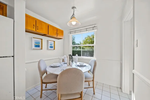 a dining room with furniture a chandelier and window