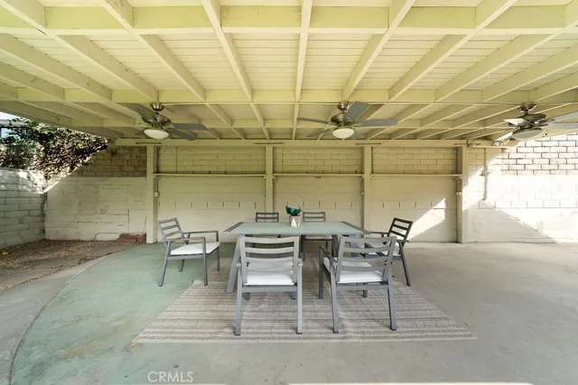 a dining room with furniture and a chandelier
