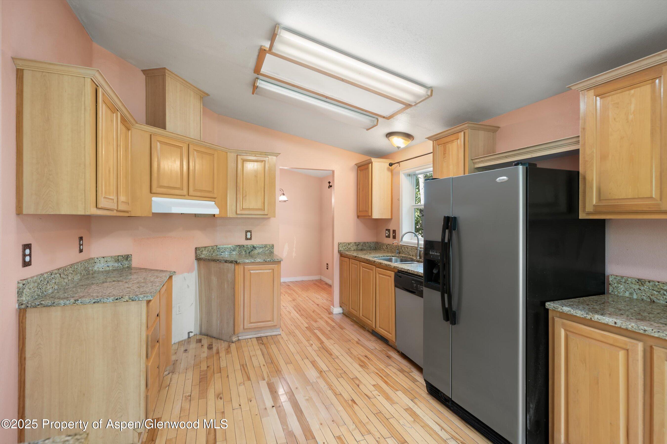 111 Ridge Trail Aspen, CO 81611 - Photo 11 of 37 a kitchen with granite countertop stainless steel appliances a refrigerator a stove top oven a sink and dishwasher