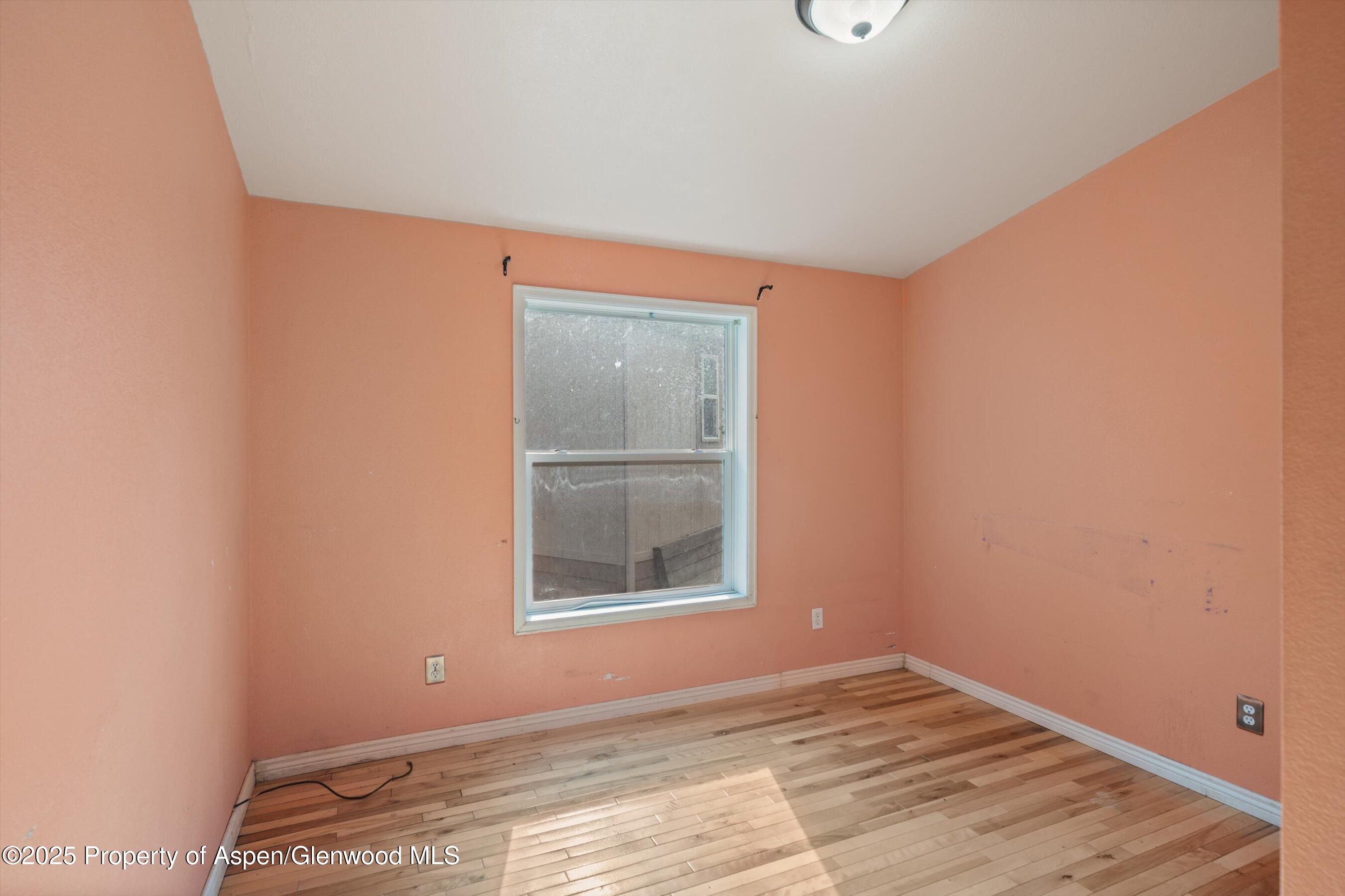 111 Ridge Trail Aspen, CO 81611 - Photo 18 of 37 a view of an empty room with wooden floor and a window