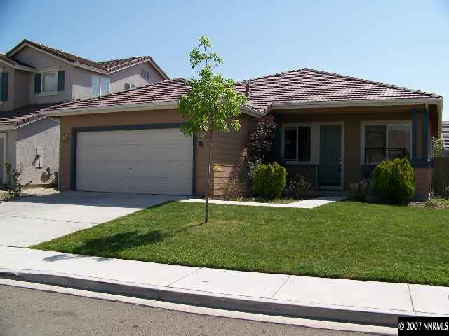 a view of a house with a garden and plants