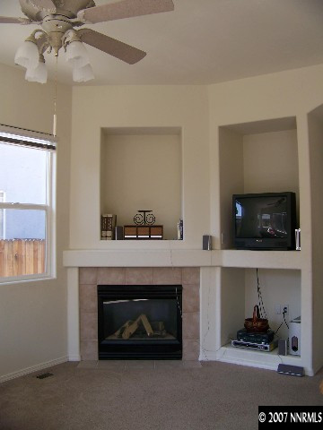 9631 Comanche Moon Drive Reno, NV 89521 - Photo 5 of 9 a living room with furniture and a fireplace