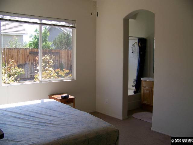 9631 Comanche Moon Drive Reno, NV 89521 - Photo 6 of 9 a bed room with a bed and a window