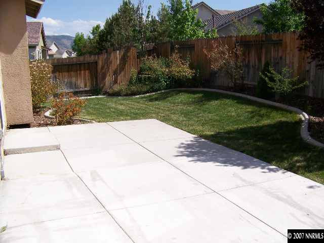 9631 Comanche Moon Drive Reno, NV 89521 - Photo 8 of 9 a backyard of a house with lots of green space