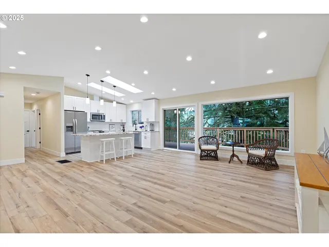 a living room with kitchen island furniture and a wooden floor