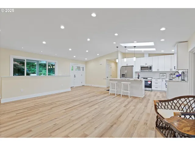 a room with pool table windows and wooden floor