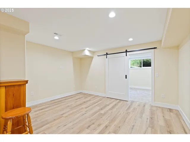 a view of empty room with wooden floor