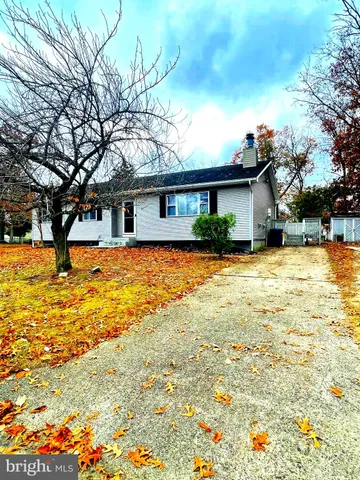 a view of a house with pool and a yard