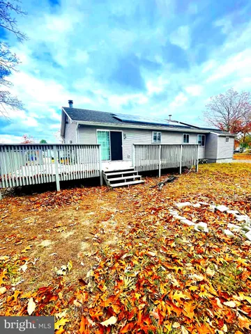 a view of a house with a backyard and balcony