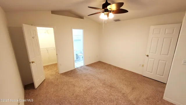 a view of empty room with ceiling fan