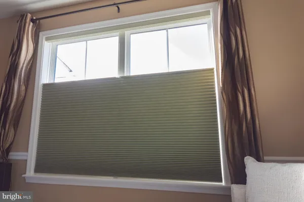 a view of a dining room with furniture and a window