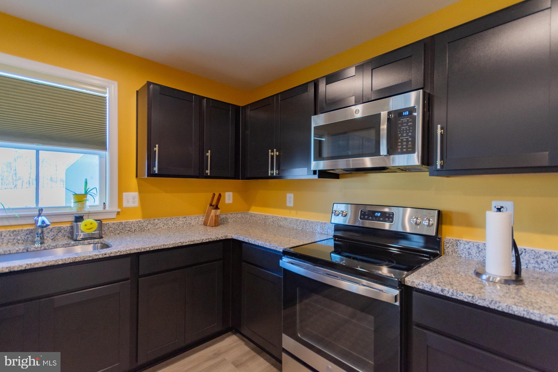 236 Surplus Road Inwood, WV 25428 - Photo 22 of 72 a kitchen with a sink and wooden cabinets