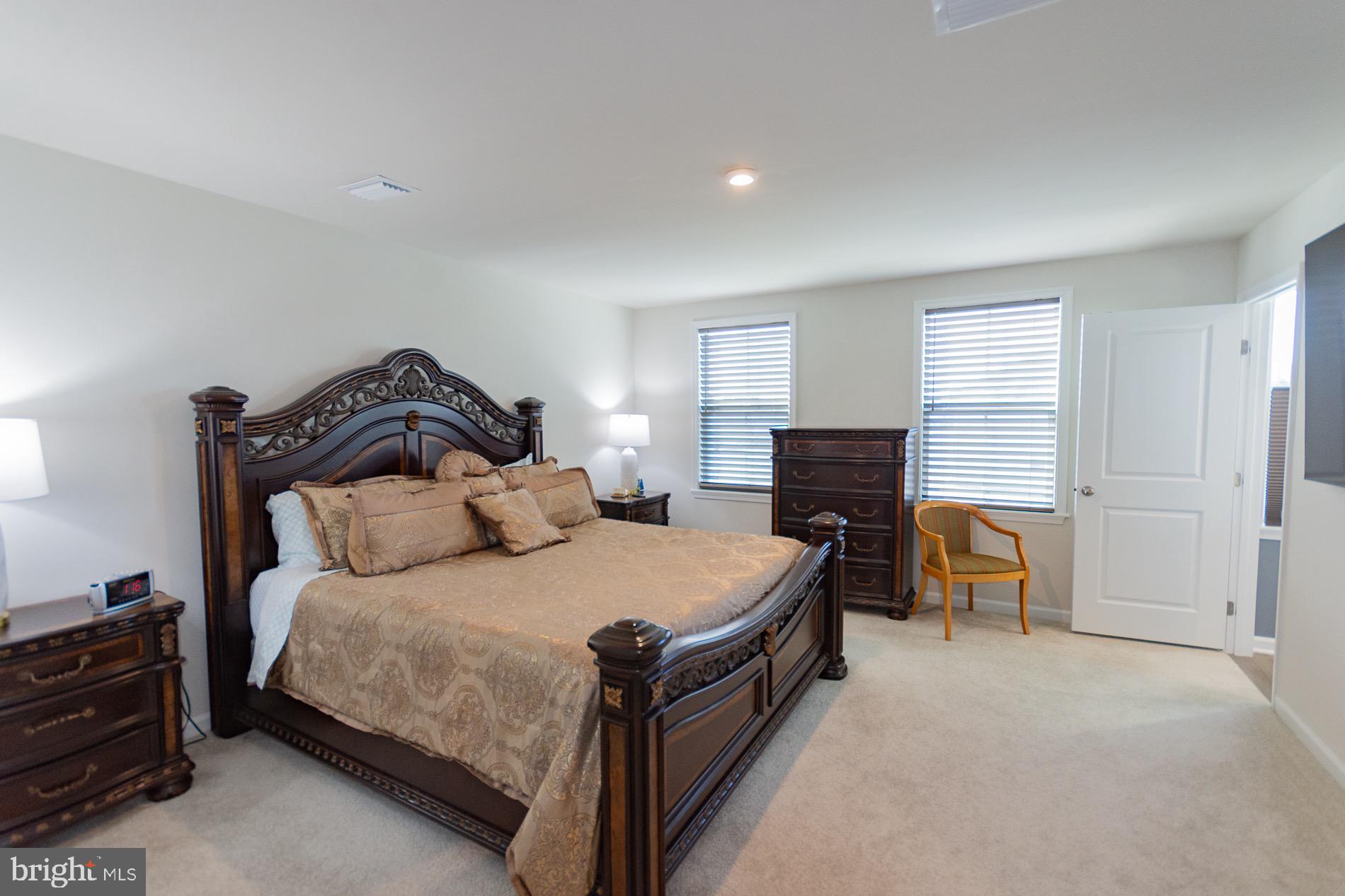 236 Surplus Road Inwood, WV 25428 - Photo 30 of 72 a bedroom with a bed and a chair