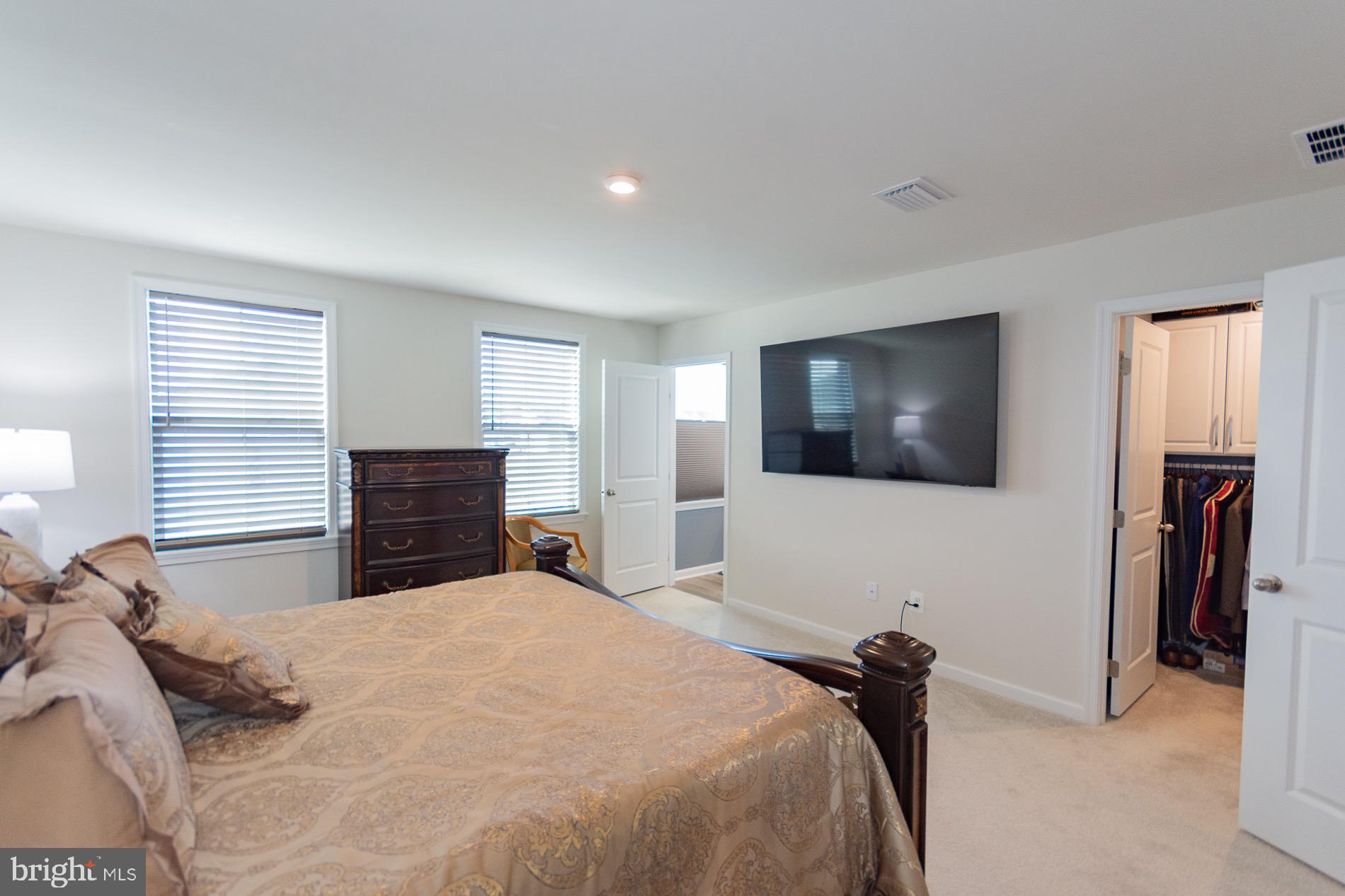 236 Surplus Road Inwood, WV 25428 - Photo 31 of 72 a bedroom with a bed and a flat screen tv