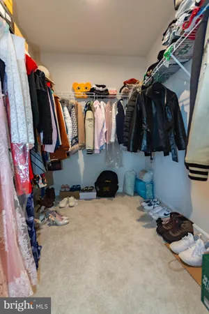 a bedroom with a bed and a mirror on dresser