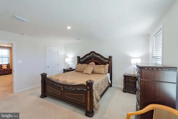 a bedroom with a bed and a tv