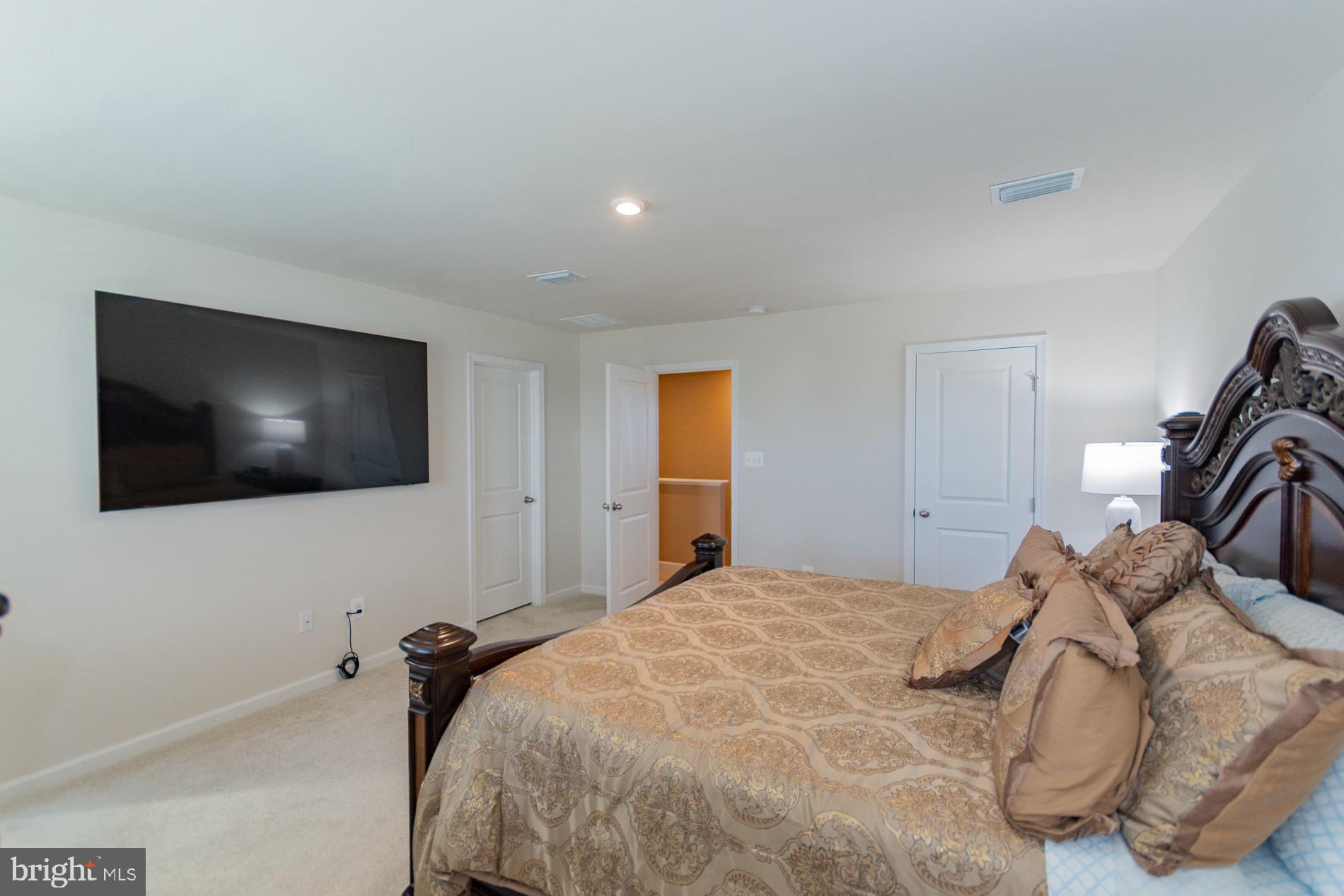 236 Surplus Road Inwood, WV 25428 - Photo 36 of 72 a bedroom with a bed and a flat screen tv