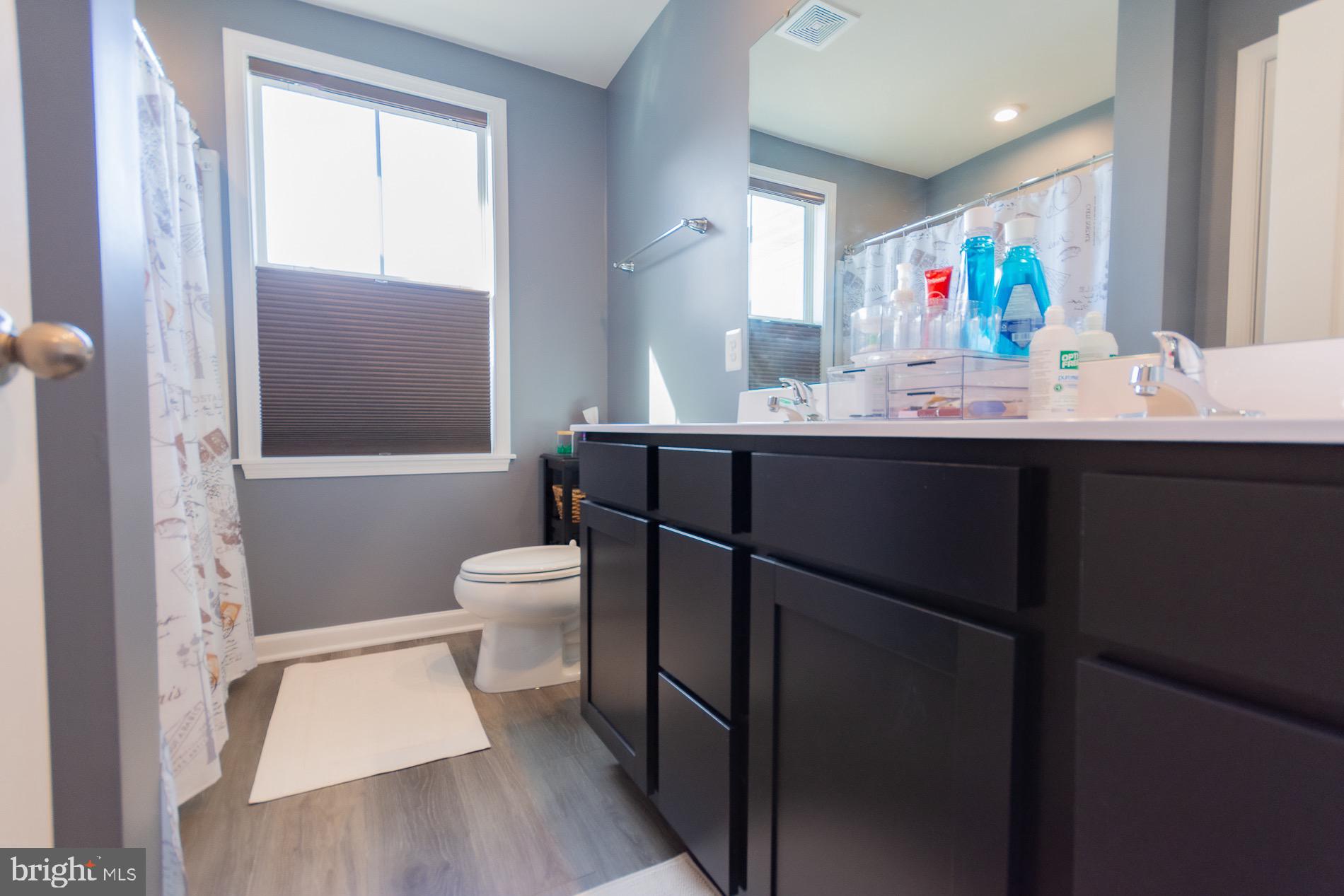 236 Surplus Road Inwood, WV 25428 - Photo 38 of 72 a bathroom with a sink a toilet a mirror and shower