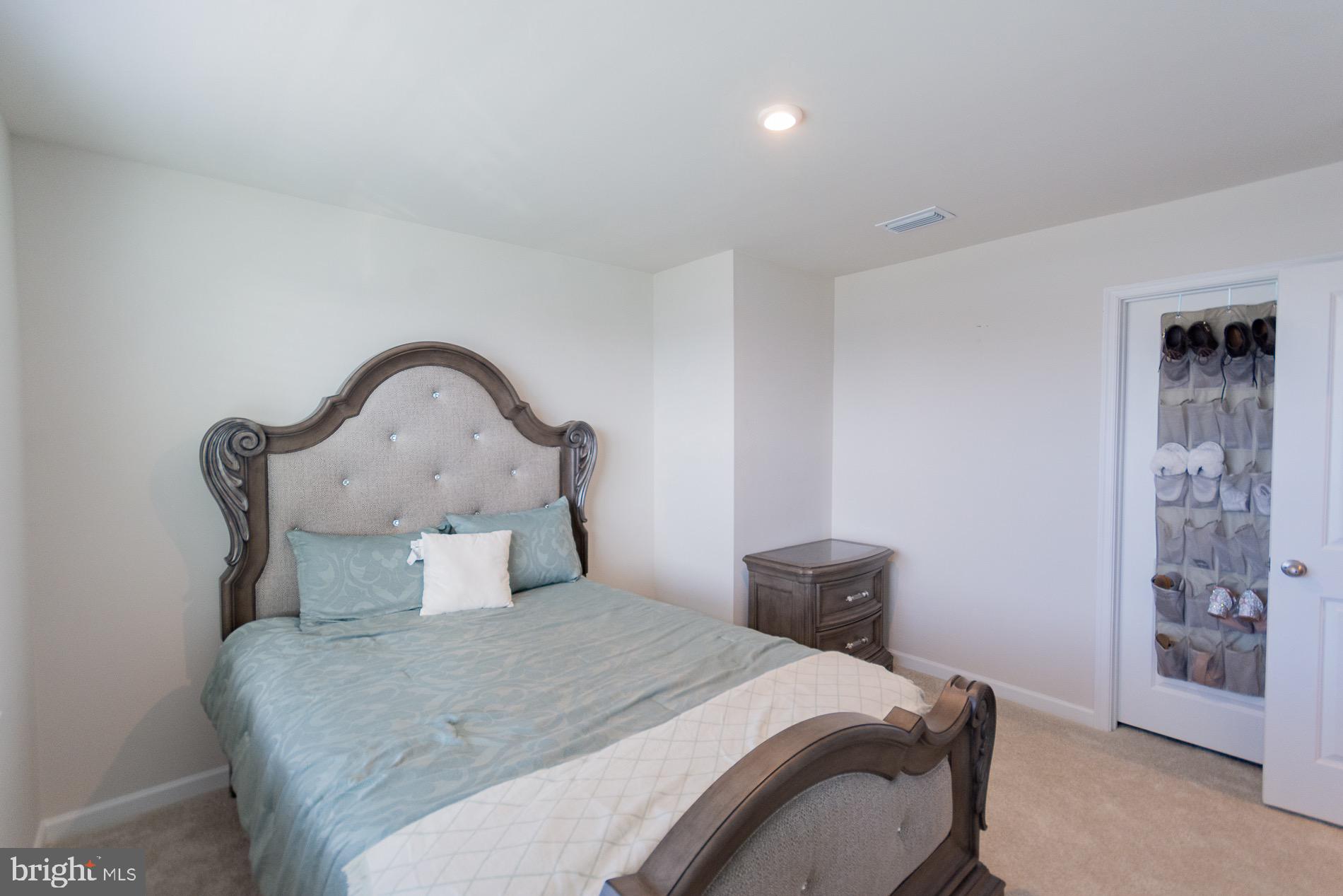 236 Surplus Road Inwood, WV 25428 - Photo 40 of 72 a bedroom with a bed and a painting on the wall