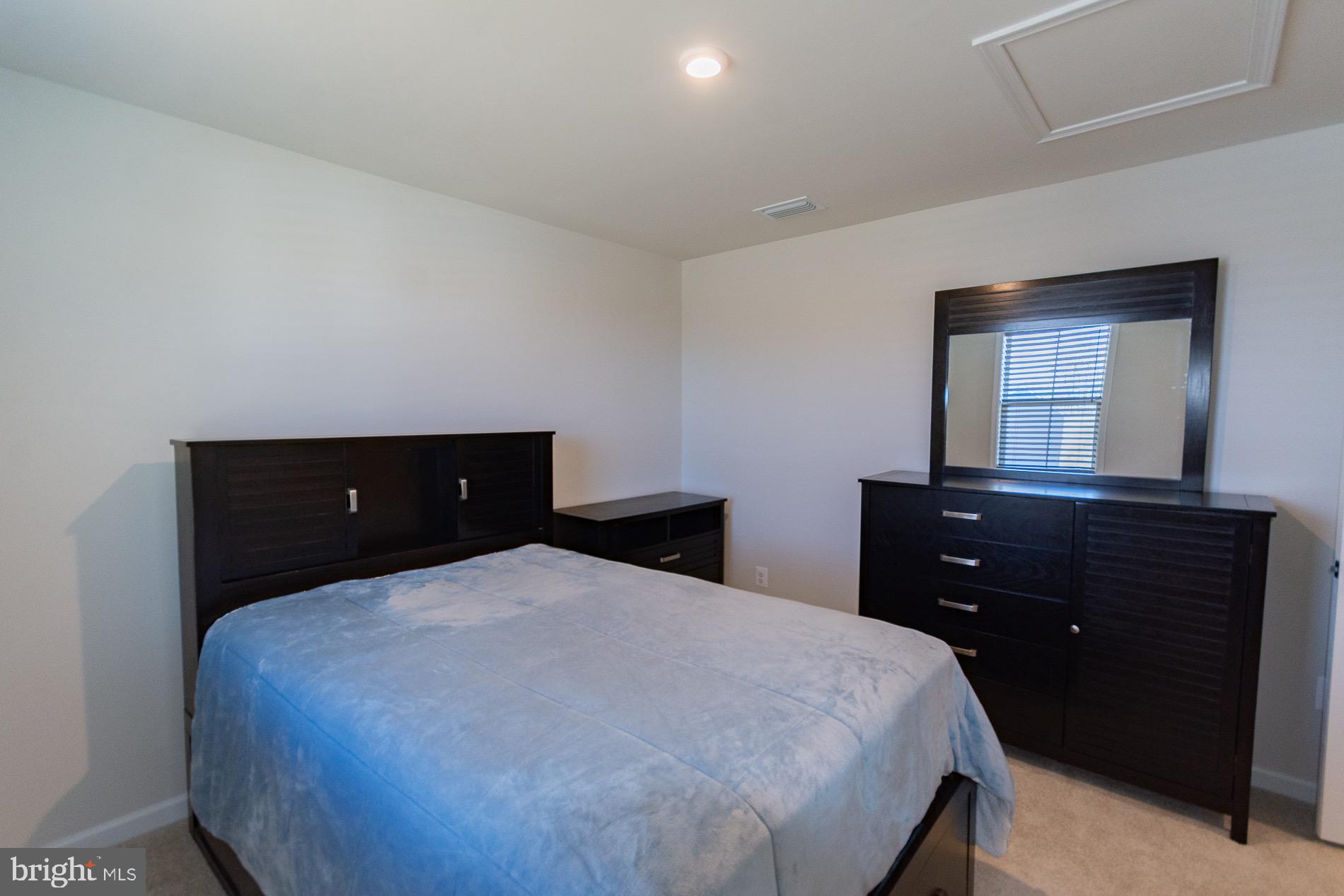 236 Surplus Road Inwood, WV 25428 - Photo 43 of 72 a bedroom with a bed and a mirror on dresser