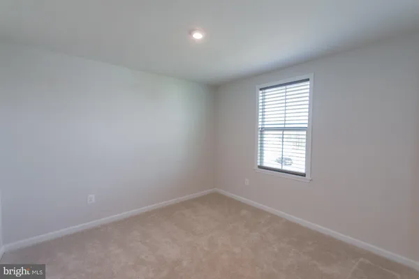 a view of a house with snow on the road